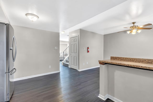 interior space with dark wood-type flooring and ceiling fan