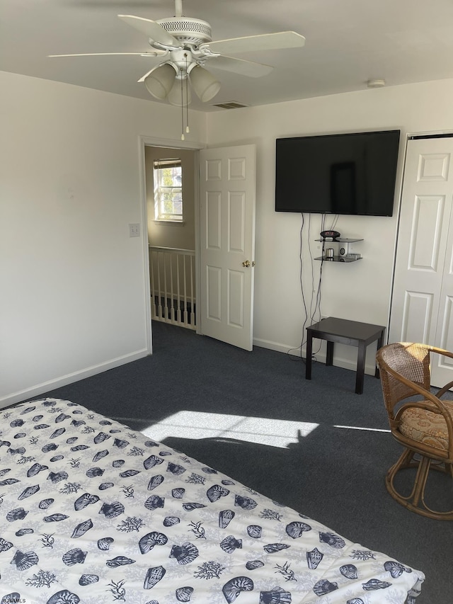 bedroom featuring dark colored carpet and ceiling fan