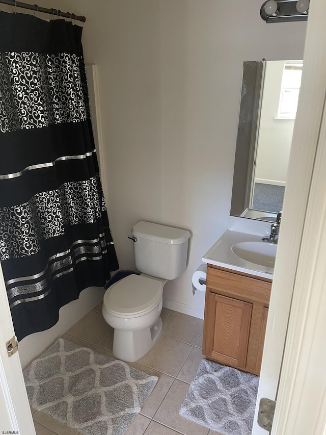 bathroom featuring tile patterned flooring, vanity, and toilet