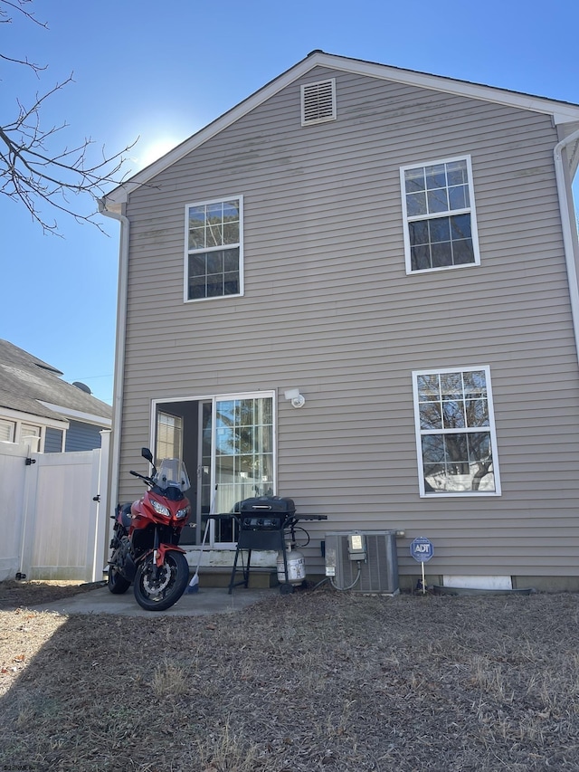 rear view of house with central AC unit