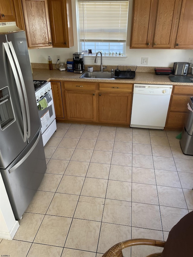 kitchen with light tile patterned flooring, sink, and white appliances