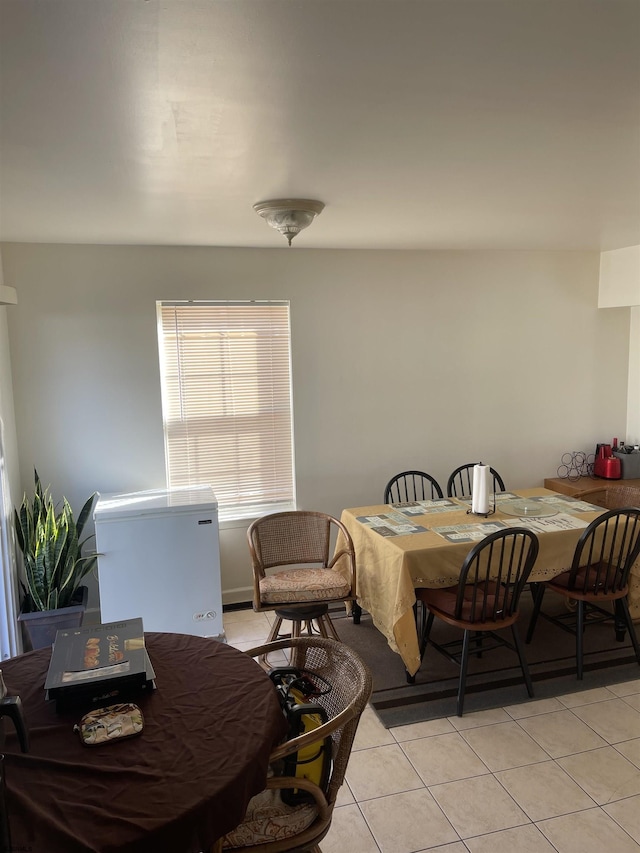 dining space featuring light tile patterned floors