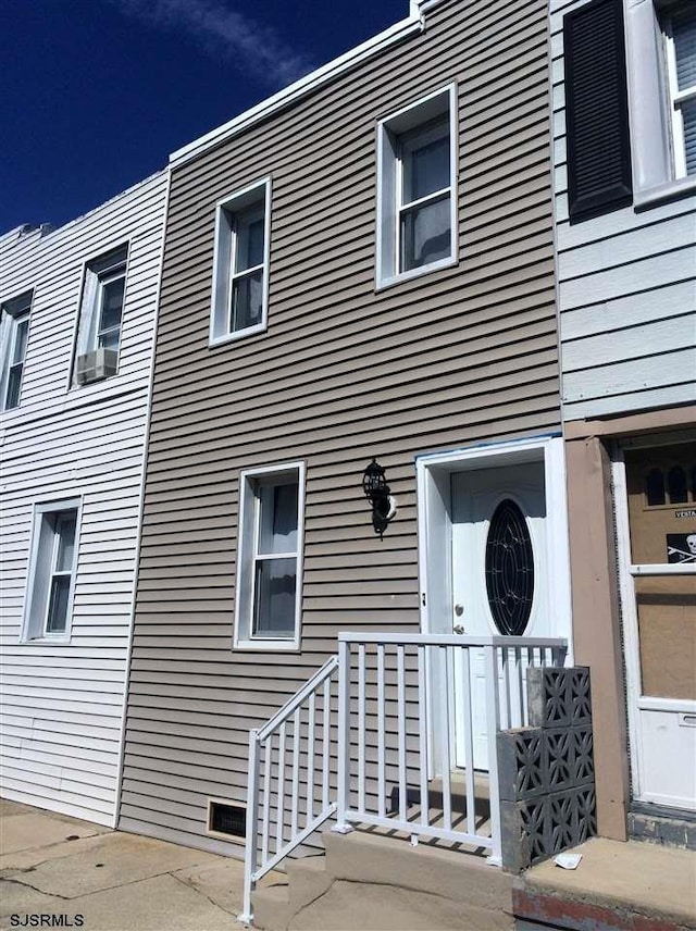 view of side of property with cooling unit