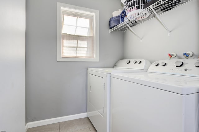 washroom featuring light tile patterned floors and washer and clothes dryer