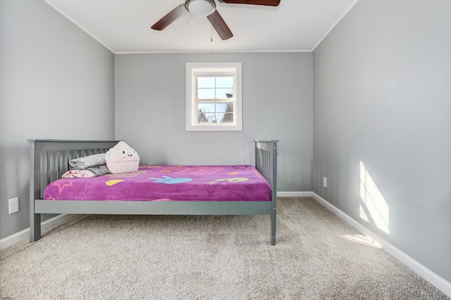 carpeted bedroom with ceiling fan and ornamental molding