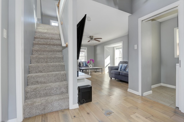 stairway featuring hardwood / wood-style floors and ceiling fan