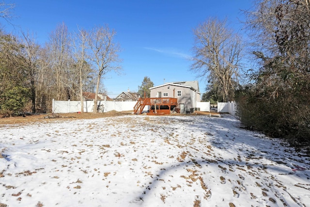 snowy yard with a deck