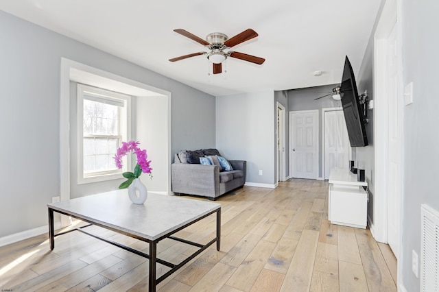 living room featuring ceiling fan and light wood-type flooring