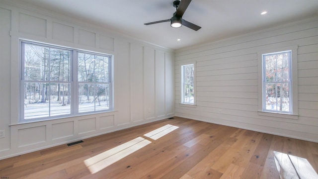 unfurnished room featuring crown molding, ceiling fan, and light hardwood / wood-style floors