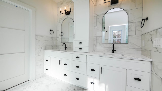 bathroom featuring vanity and tile walls