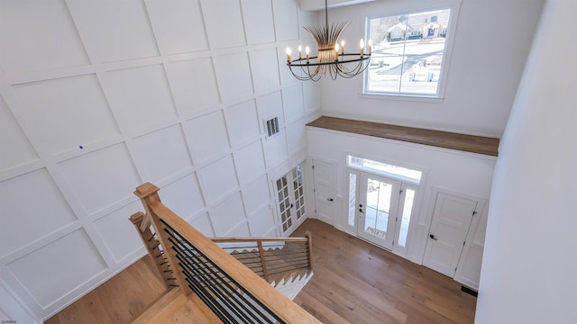 foyer with light hardwood / wood-style floors and a chandelier