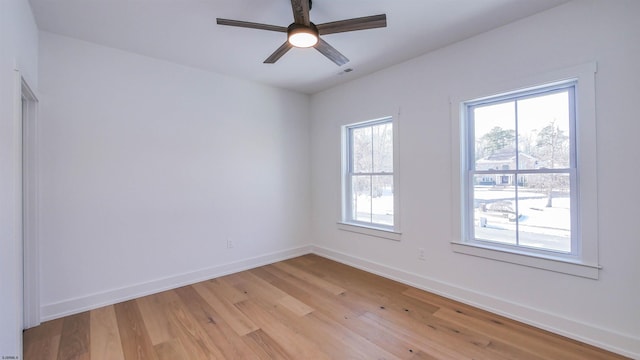 spare room featuring light hardwood / wood-style floors and ceiling fan