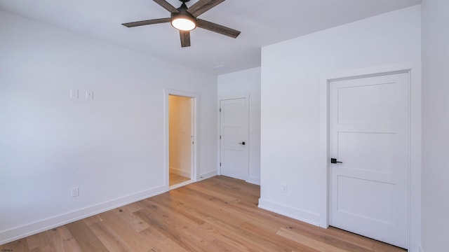 empty room with ceiling fan and light wood-type flooring