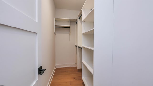 spacious closet with light hardwood / wood-style floors