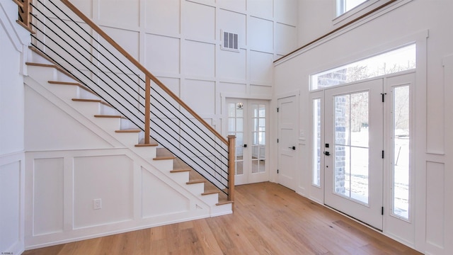 foyer featuring a high ceiling and light hardwood / wood-style floors