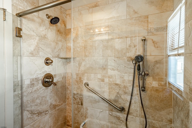 bathroom featuring a shower with shower door