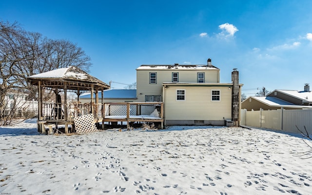 snow covered rear of property featuring a gazebo and a wooden deck