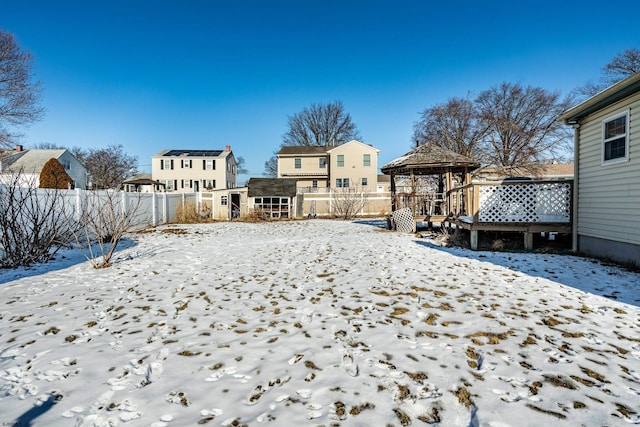 yard layered in snow featuring a gazebo and an outdoor structure