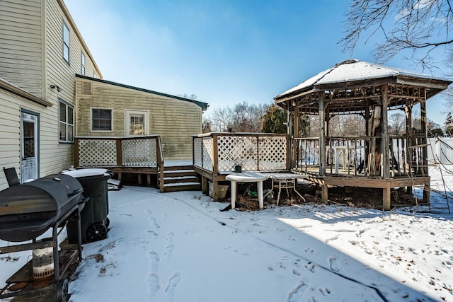 snow covered deck with area for grilling and a gazebo