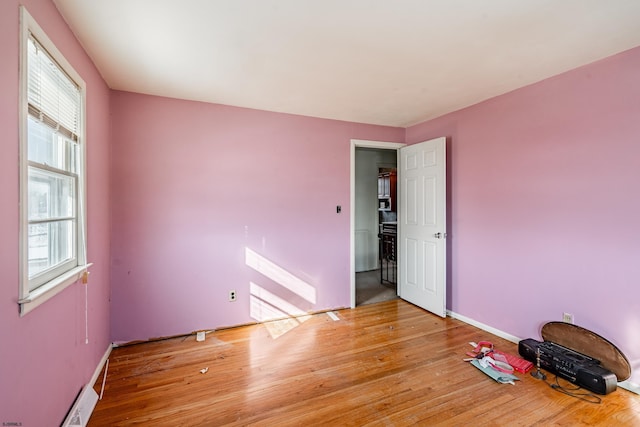 unfurnished room with light hardwood / wood-style floors