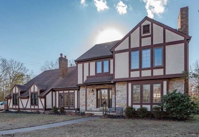 rear view of property with a lawn