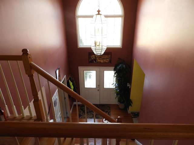 foyer with french doors and a chandelier