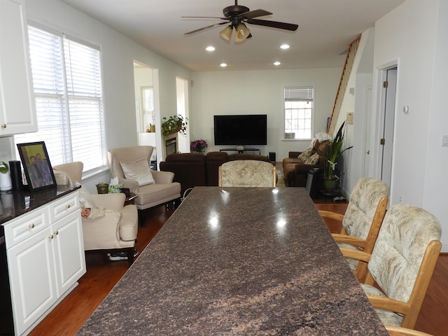 dining area with dark hardwood / wood-style flooring, a wealth of natural light, and ceiling fan