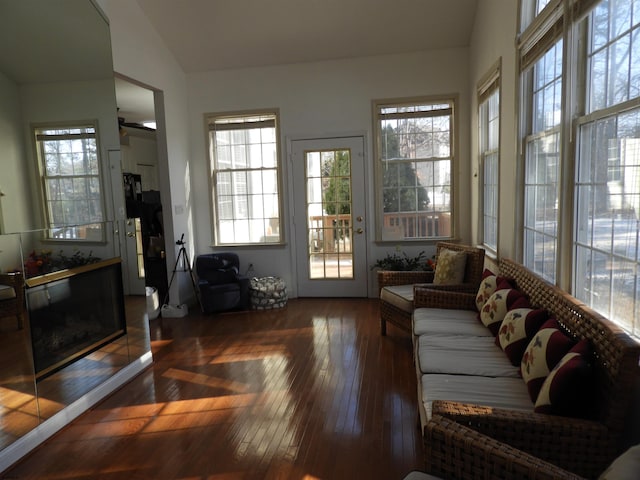 sunroom / solarium with lofted ceiling and a fireplace