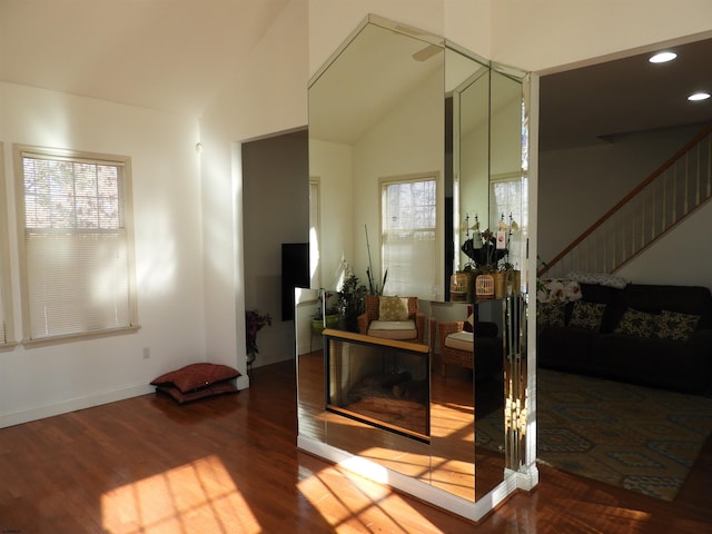 interior space with wood-type flooring and vaulted ceiling