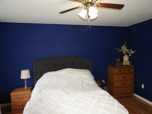 bedroom featuring hardwood / wood-style floors and ceiling fan