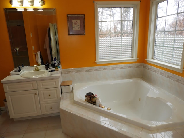 bathroom with a wealth of natural light, tile patterned floors, and tiled bath