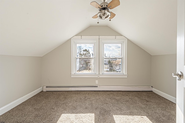 additional living space with ceiling fan, carpet floors, vaulted ceiling, and a baseboard heating unit