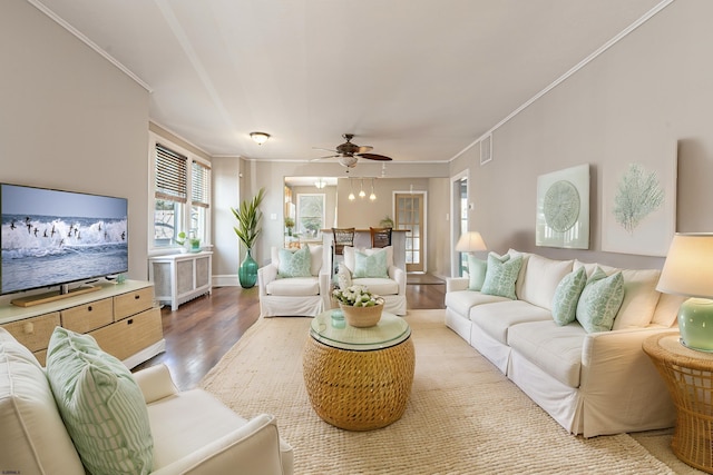 living room featuring crown molding, light hardwood / wood-style flooring, and ceiling fan