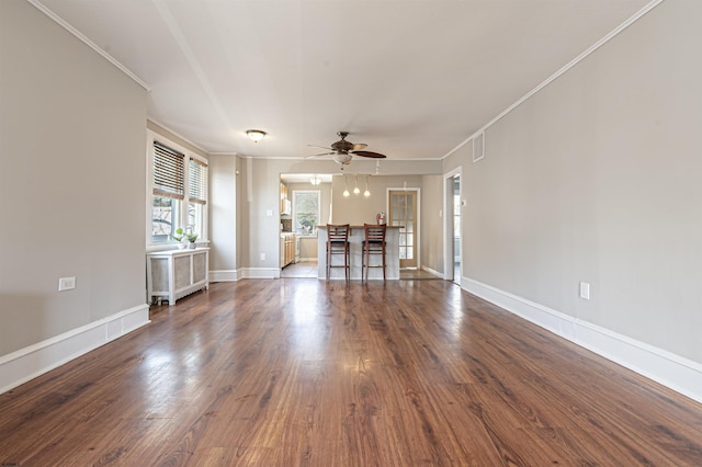 unfurnished living room featuring crown molding, dark hardwood / wood-style floors, and ceiling fan