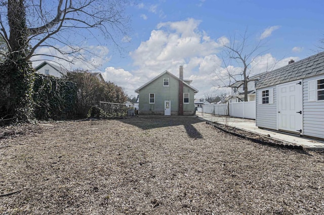 rear view of house featuring an outbuilding