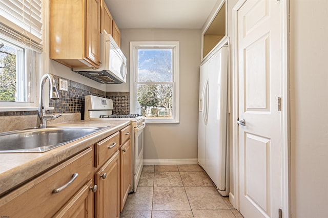 kitchen with light tile patterned flooring, sink, white appliances, and decorative backsplash