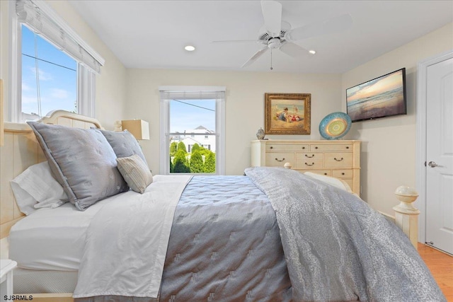 bedroom with light hardwood / wood-style floors and ceiling fan