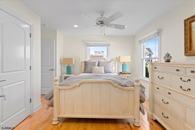 bedroom with light hardwood / wood-style flooring and ceiling fan