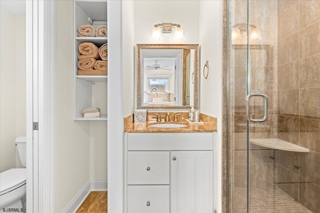 bathroom featuring walk in shower, vanity, and toilet