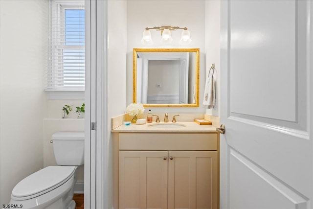 bathroom featuring vanity and toilet