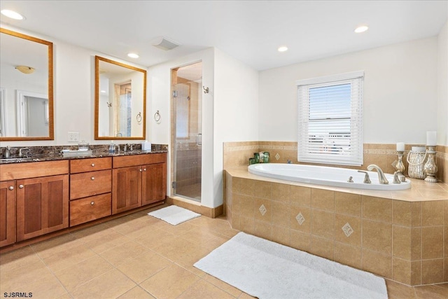 bathroom with tile patterned floors, separate shower and tub, and vanity