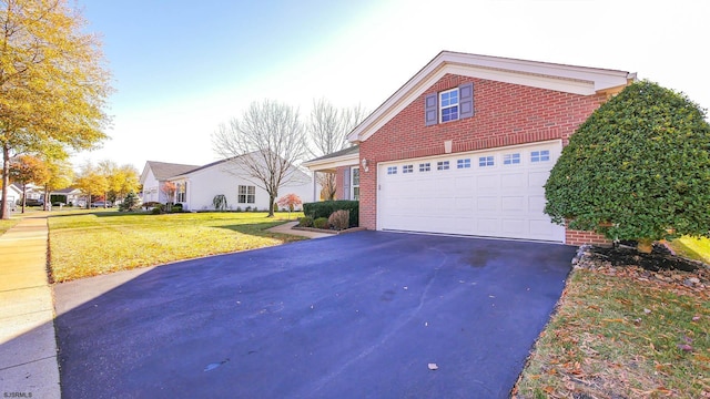 view of front of property featuring a garage and a front lawn