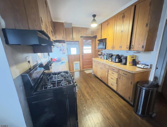 kitchen featuring hardwood / wood-style floors and black appliances