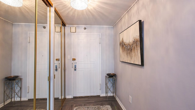 entryway with crown molding and dark hardwood / wood-style floors