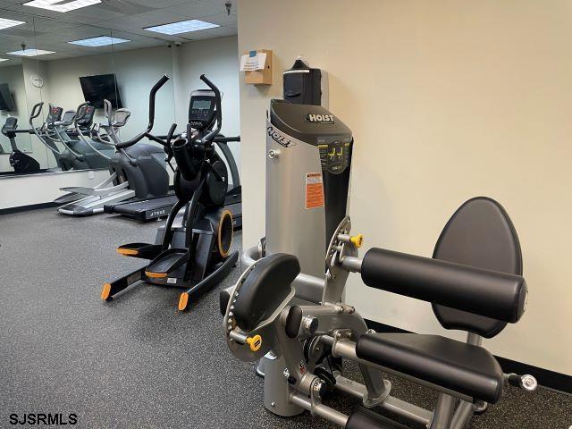 exercise room with a paneled ceiling