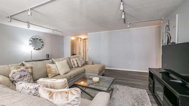 living room featuring track lighting and dark hardwood / wood-style flooring