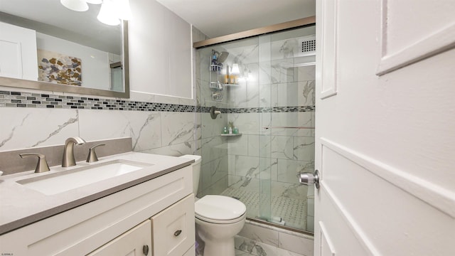 bathroom featuring vanity, walk in shower, and toilet