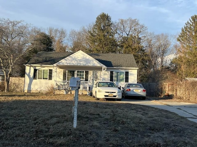 ranch-style home with covered porch and a front lawn