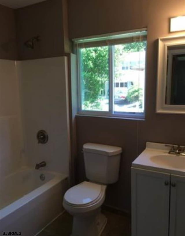 full bathroom with vanity, bathtub / shower combination, and toilet