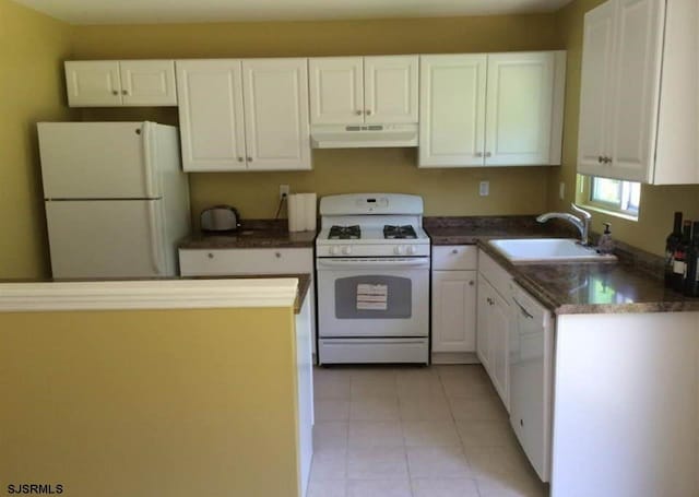 kitchen featuring white cabinetry, sink, light tile patterned flooring, and white appliances